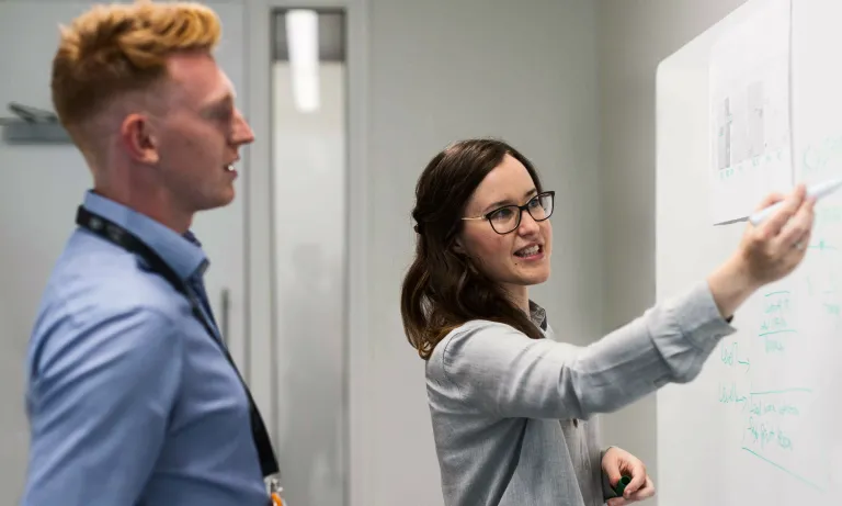 woman and man at whiteboard